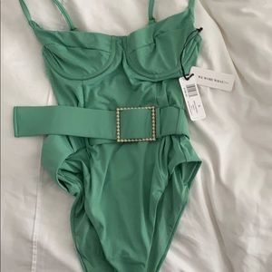 NWT. We Wore What “Danielle” one piece in green.